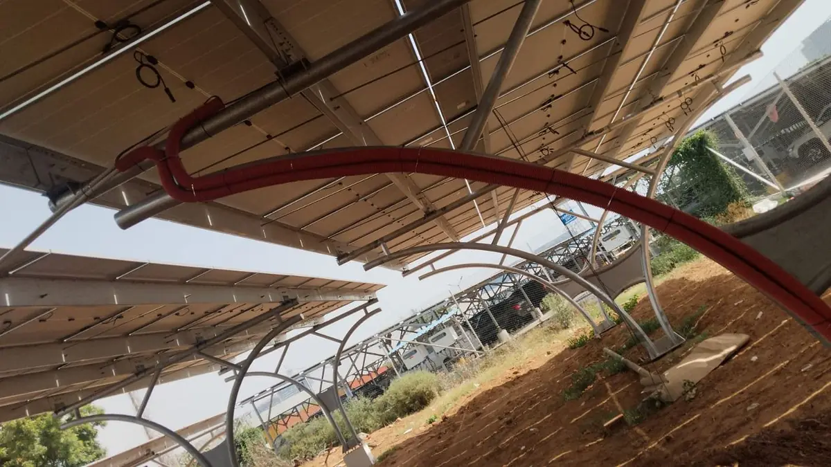 DC cables routed in red conduit beneath the finished carport canopy